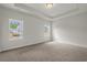 Bedroom with neutral carpet, a tray ceiling, and two large windows at 1212 Nw Calabash Station Blvd., Calabash, NC 28467