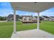 View from covered patio with white columns overlooking a lawn, new homes, and blue sky at 1212 Nw Calabash Station Blvd., Calabash, NC 28467