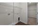 Well-lit laundry room featuring wood flooring, wire shelving, utility connections, and pet door at 1212 Nw Calabash Station Blvd., Calabash, NC 28467