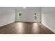 Open living room with hardwood floors, a ceiling fan, and a back door at 1212 Nw Calabash Station Blvd., Calabash, NC 28467