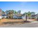 Gray house with a two car garage and palm trees at 1437 Windwood Crossing, Surfside Beach, SC 29575