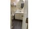 Clean bathroom with white vanity and oval mirror at 1650 Deer Creek Rd., Surfside Beach, SC 29575