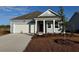 Gray one-story house with a white garage door and red front door at 183 Calm Dr., Little River, SC 29566