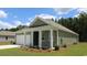 Green one-story house with a white garage door and front porch at 183 Calm Dr., Little River, SC 29566