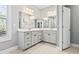 Double vanity bathroom with gray cabinets and a large mirror at 208 Switch Grass Ct., Myrtle Beach, SC 29579