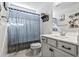 Small bathroom with a white vanity and gray shower curtain at 208 Switch Grass Ct., Myrtle Beach, SC 29579