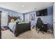 Bedroom with a dark-brown wooden bed frame and gaming setup at 208 Switch Grass Ct., Myrtle Beach, SC 29579
