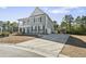 Two-story home with gray siding, balcony, and large driveway at 208 Switch Grass Ct., Myrtle Beach, SC 29579