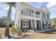 Two-story home with gray siding, balcony and palm tree at 208 Switch Grass Ct., Myrtle Beach, SC 29579