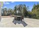 Spacious patio with outdoor dining set and wooded backdrop at 208 Switch Grass Ct., Myrtle Beach, SC 29579
