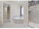 Relaxing bathroom featuring a soaking tub, shower, and natural light from the window at 2113 Clematis Ct., Myrtle Beach, SC 29579