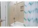 Clean bathroom showcasing neutral tile shower with a white tub and a modern shower curtain at 2113 Clematis Ct., Myrtle Beach, SC 29579