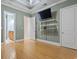 Spacious bedroom with a modern TV, shelving, and en-suite bathroom entrance at 2113 Clematis Ct., Myrtle Beach, SC 29579