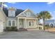 Inviting two-story home with a manicured lawn, a palm tree, and a welcoming front porch at 2113 Clematis Ct., Myrtle Beach, SC 29579