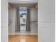 Bright walk-in closet with a window, hardwood floors, and custom wood shelving for optimal organization at 2113 Clematis Ct., Myrtle Beach, SC 29579