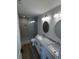 Modern bathroom boasts a double marble vanity, wood-look floors, and a glass-enclosed shower at 229 South Waccamaw Dr., Garden City Beach, SC 29576