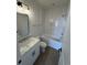 Bathroom featuring a tub with white tile surround, and a vanity with marble countertop and dark fixtures at 229 South Waccamaw Dr., Garden City Beach, SC 29576