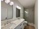 Modern bathroom with a glass shower, double sink vanity, and stylish lighting fixtures at 229 South Waccamaw Dr., Garden City Beach, SC 29576
