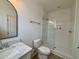 Bright bathroom featuring a modern vanity with marble countertops and a tiled walk-in shower at 229 South Waccamaw Dr., Garden City Beach, SC 29576