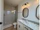 Bathroom features a modern vanity with a marble countertop and a tiled walk-in shower at 229 South Waccamaw Dr., Garden City Beach, SC 29576