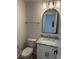 Powder room features a vanity with marble countertop, brushed nickel fixtures, and oval mirror at 229 South Waccamaw Dr., Garden City Beach, SC 29576