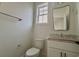 Well-lit powder room with a sleek vanity, toilet, mirror, and towel bar, offering functionality and style at 229 South Waccamaw Dr., Garden City Beach, SC 29576