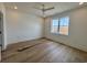 Bright bedroom with wood-look floors, a ceiling fan, and a view of a new build out the window at 229 South Waccamaw Dr., Garden City Beach, SC 29576