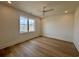 Bright bedroom featuring hardwood floors, a ceiling fan, and a large window at 229 South Waccamaw Dr., Garden City Beach, SC 29576