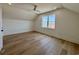 Bright bedroom featuring hardwood floors, a ceiling fan, and a window offering lots of natural light at 229 South Waccamaw Dr., Garden City Beach, SC 29576