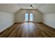 Large bedroom featuring hardwood floors, ceiling fan and a door leading to a balcony at 229 South Waccamaw Dr., Garden City Beach, SC 29576