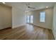 Spacious bedroom with hardwood floors, natural light, and a door to the balcony at 229 South Waccamaw Dr., Garden City Beach, SC 29576