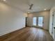 Large bedroom with hardwood floors and a door leading to a balcony at 229 South Waccamaw Dr., Garden City Beach, SC 29576