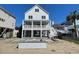 Stunning raised beach home with a crisp white exterior, spacious covered porch, and a brand new in-ground pool at 229 South Waccamaw Dr., Garden City Beach, SC 29576
