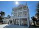 Coastal home with a multi-tiered covered porch offering ocean views and ample outdoor space at 229 South Waccamaw Dr., Garden City Beach, SC 29576
