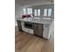 Kitchen island with modern appliances like a microwave and dishwasher, topped with a sleek marble countertop at 229 South Waccamaw Dr., Garden City Beach, SC 29576