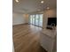 Open concept living room with wood-look floors, a sink, and sliding glass doors to the deck at 229 South Waccamaw Dr., Garden City Beach, SC 29576