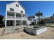 Backyard under construction with swimming pool featuring spa with white brick surround at 229 South Waccamaw Dr., Garden City Beach, SC 29576