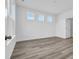 Spacious bedroom with wood-look flooring and natural light from three windows at 234 Letha Dr, Longs, SC 29568
