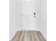 Hallway featuring modern flooring, white walls and trim, and a secure smart lock at 234 Letha Dr, Longs, SC 29568