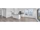 Bright kitchen features white cabinets, granite countertops, stainless appliances, and wood-look flooring at 234 Letha Dr, Longs, SC 29568