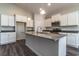 Modern kitchen with island, white cabinets, and granite countertops at 403 Lifestyle Court, Surfside Beach, SC 29575