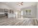 Open-concept floor plan with a kitchen, dining area, and large living space filled with natural light at 407 Lifestyle Court, Surfside Beach, SC 29575