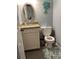 A compact bathroom featuring a granite countertop vanity and toilet with a palm tree decoration at 4714 Woodland St., North Myrtle Beach, SC 29582