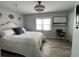 Comfortable bedroom with a queen bed, seascape artwork, and a decorative ceiling fan at 4714 Woodland St., North Myrtle Beach, SC 29582
