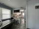 Kitchen view with breakfast bar that connects to dining area with modern decor and natural light at 4714 Woodland St., North Myrtle Beach, SC 29582