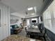 Bright open concept featuring a living room, dining area, and partial kitchen with modern decor at 4714 Woodland St., North Myrtle Beach, SC 29582