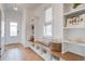 Light and airy entryway with built-in bench, shelving, and wood flooring at 512 Ayrhill Loop, Myrtle Beach, SC 29588