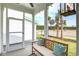 Screened porch with wooden bench, offering peaceful views at 512 Ayrhill Loop, Myrtle Beach, SC 29588