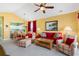 Open living space features a red sofa and a view into the kitchen at 5750 Oyster Catcher Dr. # 131, North Myrtle Beach, SC 29582