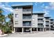 Beachfront property with gray building, balconies, and parking at 6000 N Ocean Blvd. # 205, North Myrtle Beach, SC 29582
